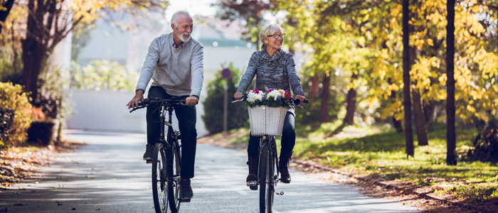 elderly couple riding bicycles 